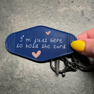 Sleutelhanger met tekst ‘I’m just here to hold the bird’ – voor papegaaienliefhebbers